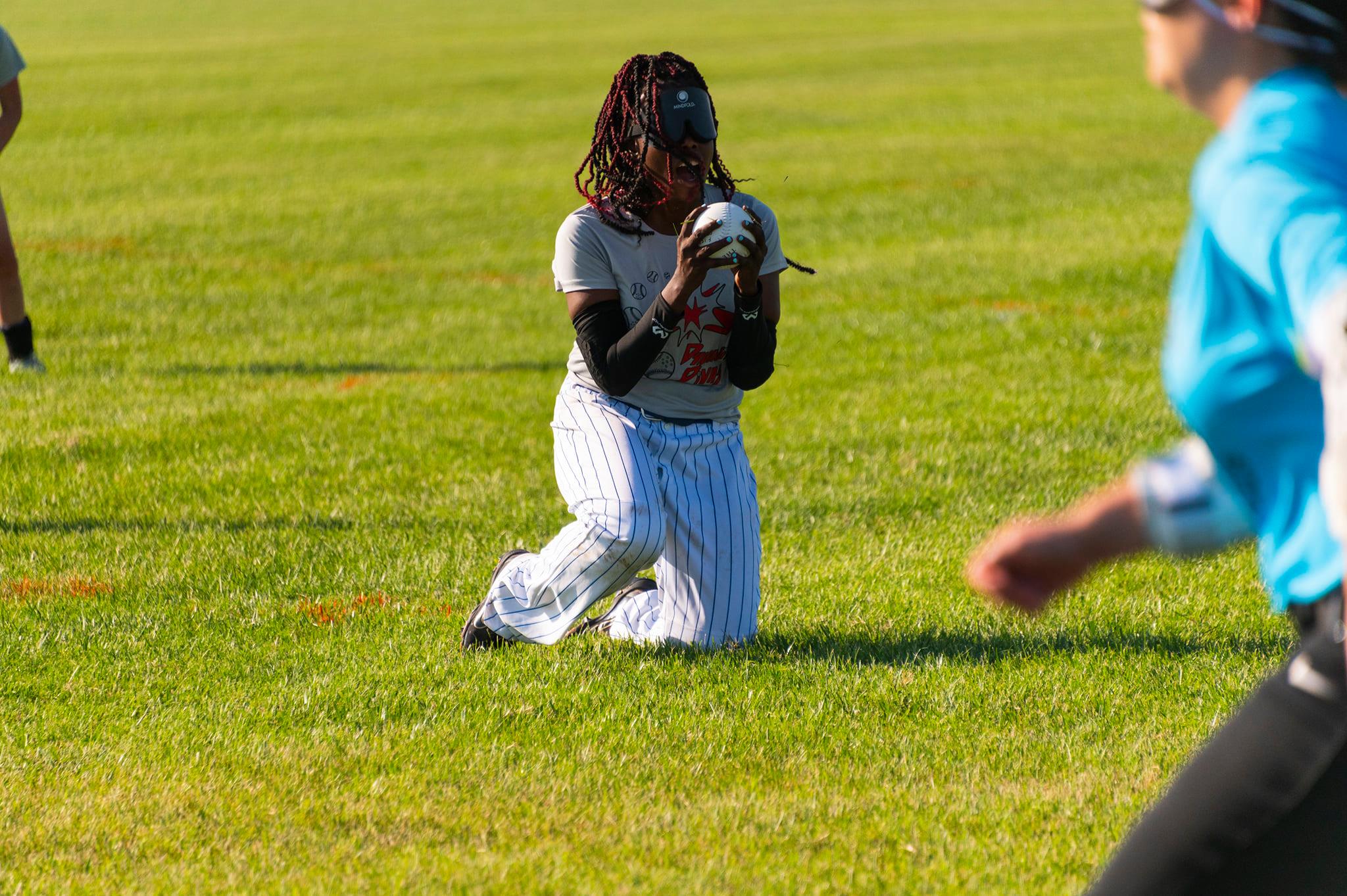 Kalari comes up to her knees lifting the ball up in front of her